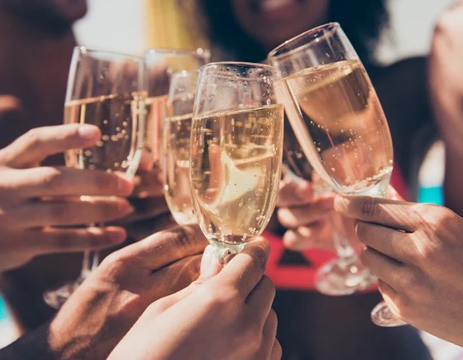 A toast with multiple glasses of champagne.