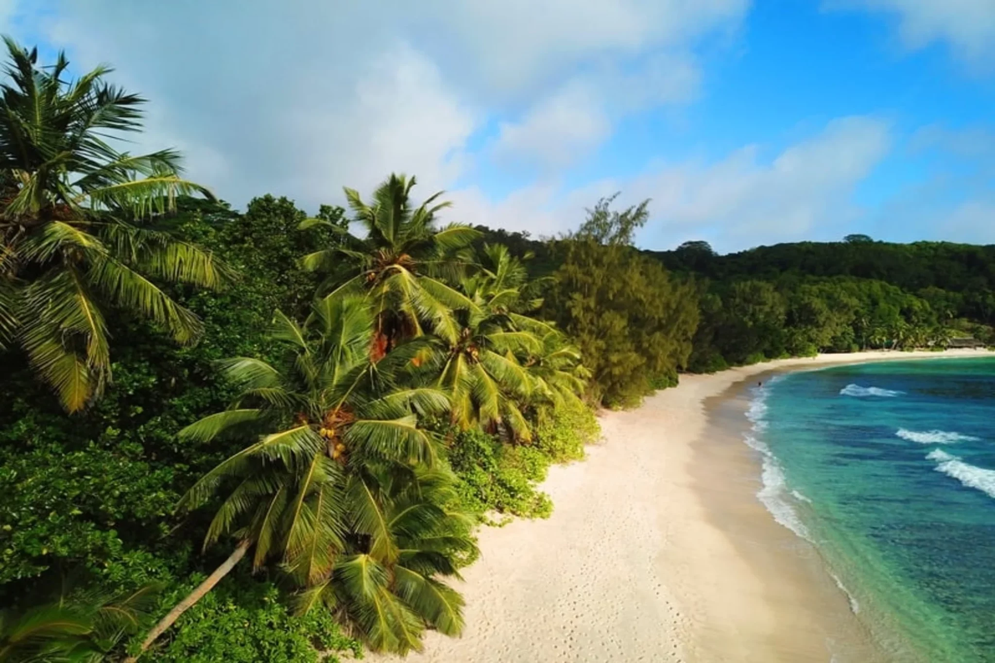 A peaceful Seychelles beach on a sunny day.