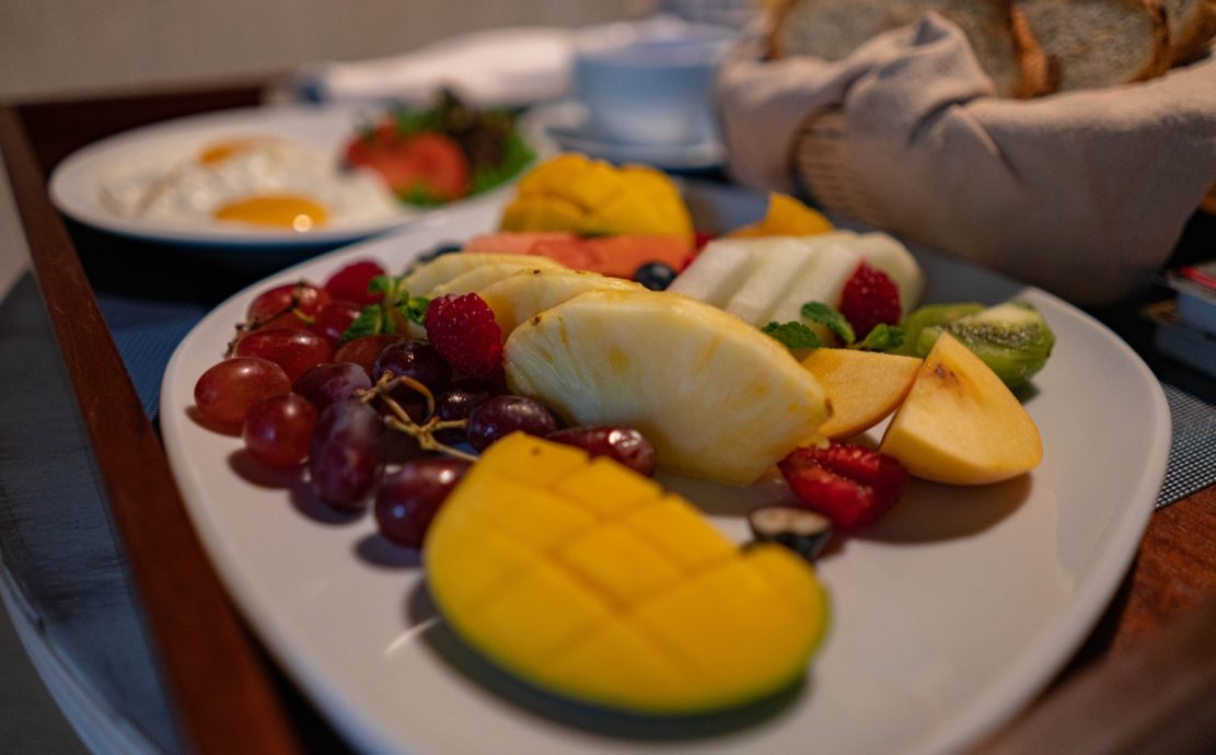 A colorful fruit platter with a variety of fresh fruits served in a Seychelles restaurant.