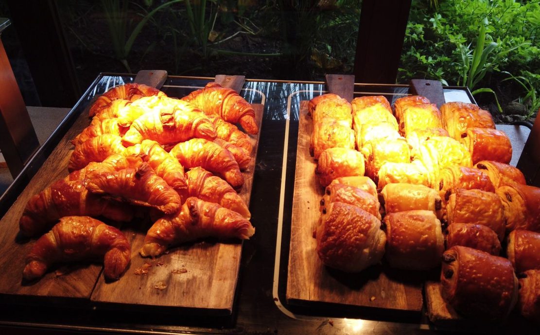 Freshly baked croissants and pastries on display at a resort