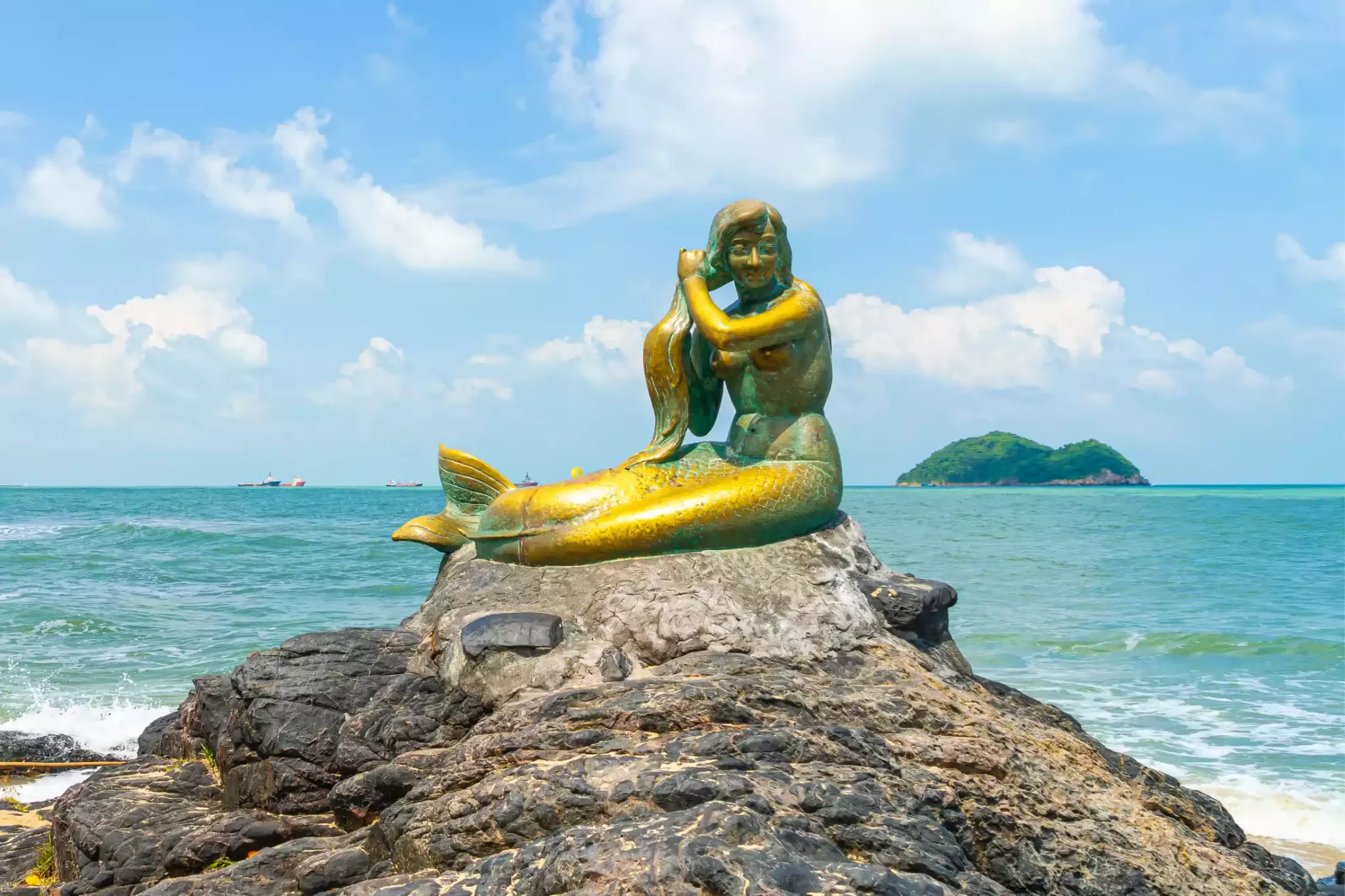 Golden mermaid statues on Samila beach in Thailand.