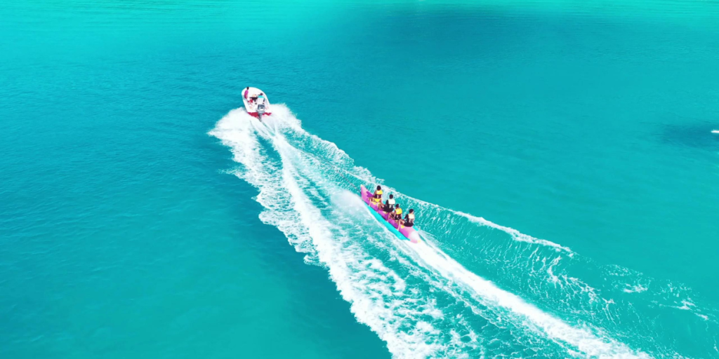 A banana boat ride on the vibrant blue waters of the Seychelles, a popular water activity for visitors.