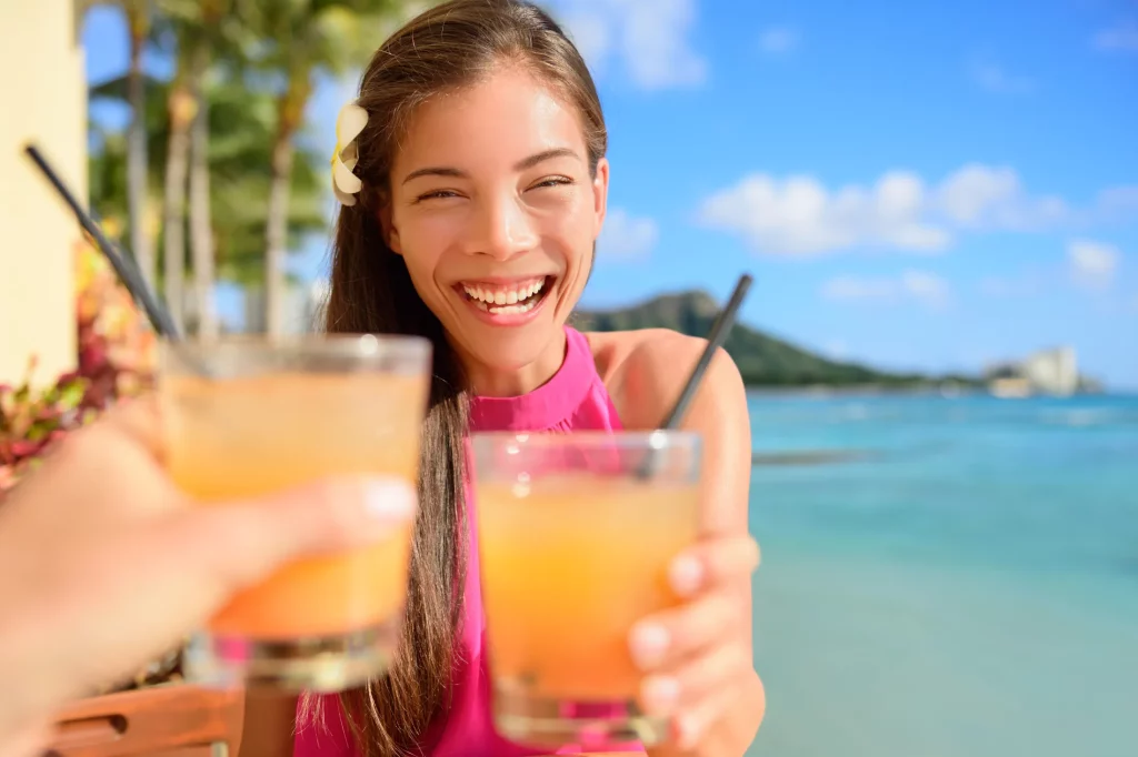 A lady enjoying a cocktail on Beau Vallon Beach in Seychelles.