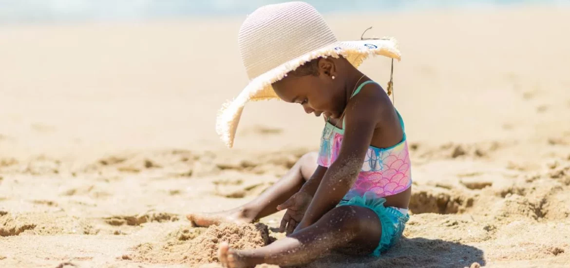 Small child playing in the sand.