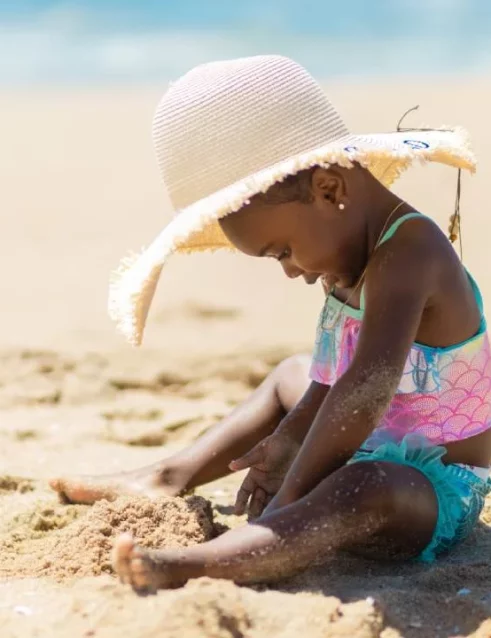 Small child playing in the sand.