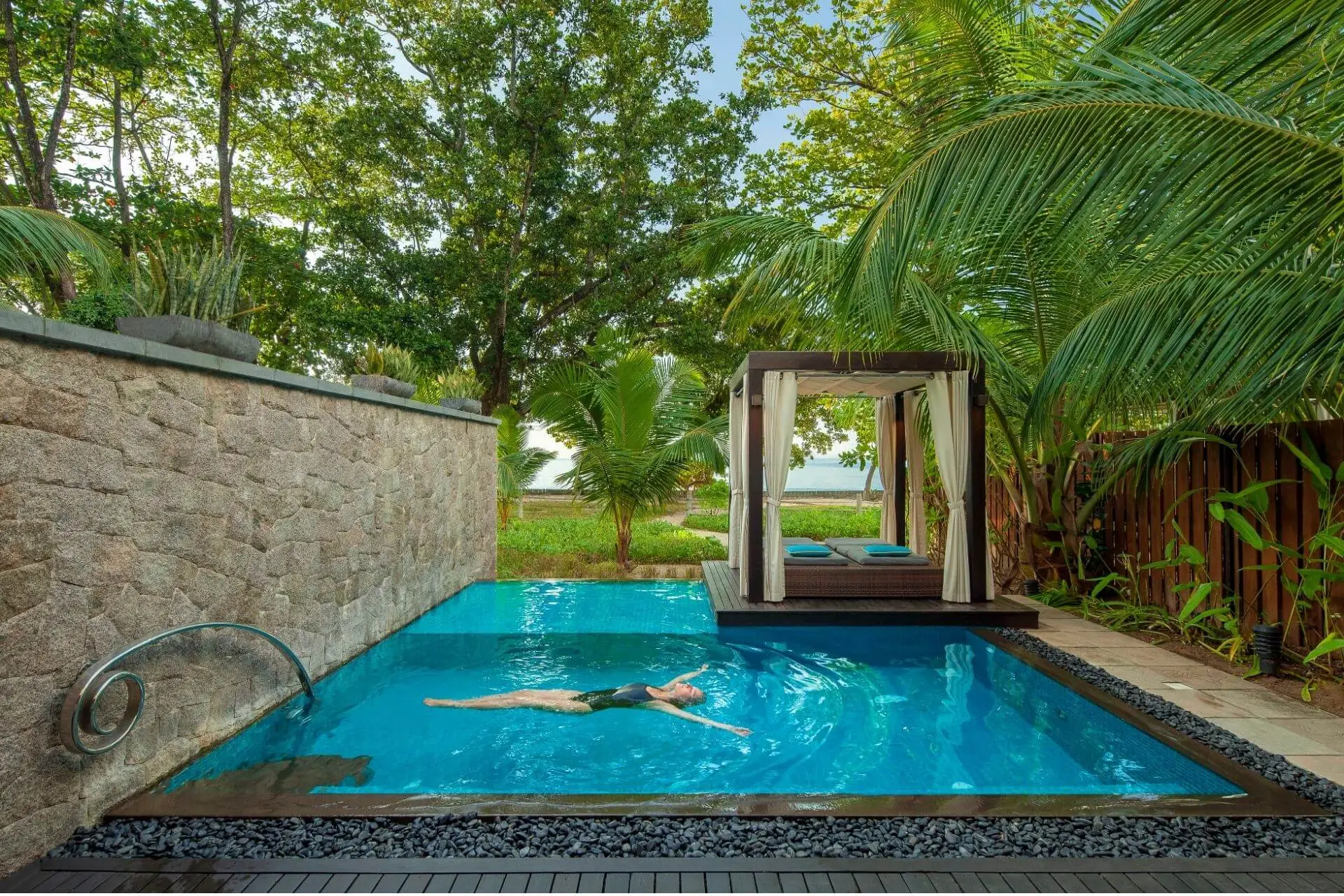 A private villa pool in Seychelles with a cosy cabana.