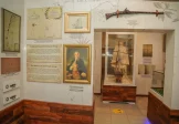 Seychelles National History Museum exhibit displaying historical maps, artifacts, and a model ship related to French exploration.