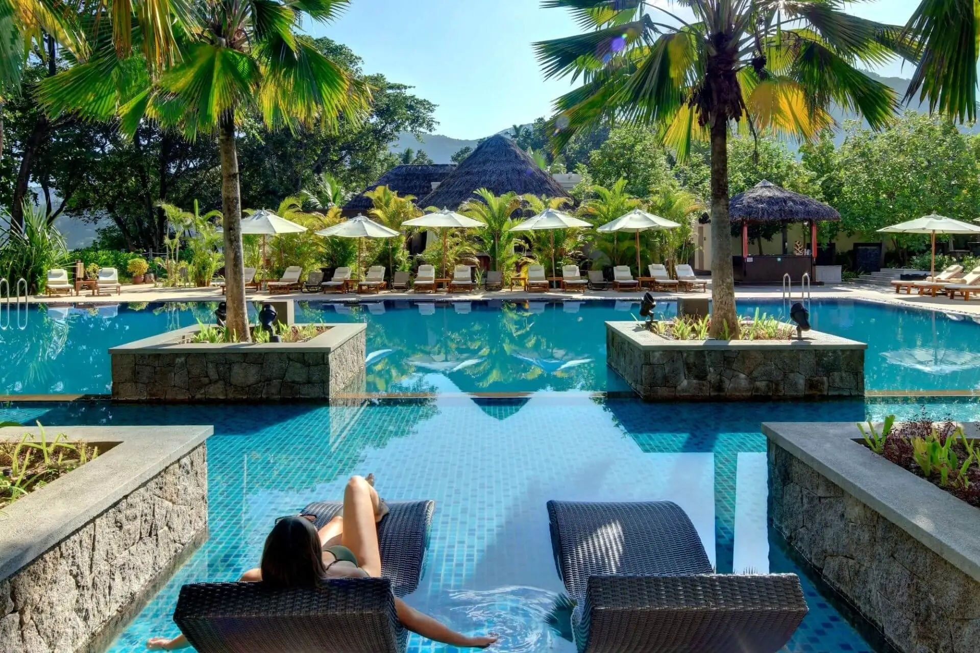 Lush green poolside area in the Story Seychelles Resort