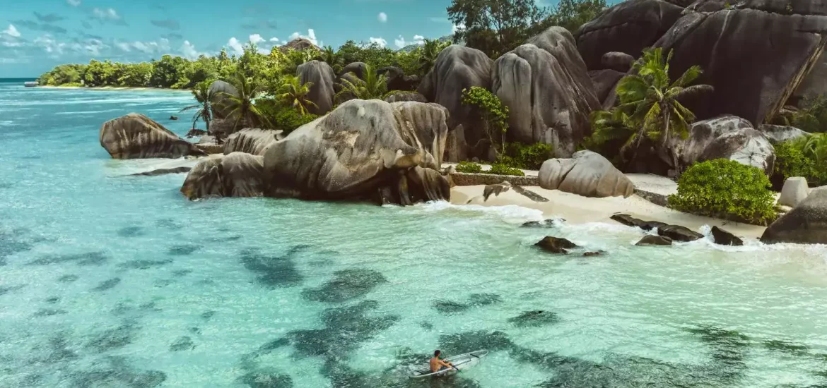 Aerial view of Seychelles beach with granite boulders and turquoise water during dry season